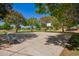 Outdoor basketball court with benches under shade trees at 23242 S 202Nd Way, Queen Creek, AZ 85142