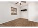 Bedroom with wood-look floors, window, and ceiling fan at 23242 S 202Nd Way, Queen Creek, AZ 85142