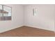 Well-lit bedroom with wood-look floors and window blinds at 23242 S 202Nd Way, Queen Creek, AZ 85142