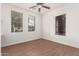 Bright bedroom with wood-look floors and ceiling fan at 23242 S 202Nd Way, Queen Creek, AZ 85142