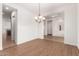 Bright dining room with hardwood floors and chandelier at 23242 S 202Nd Way, Queen Creek, AZ 85142