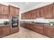 Modern kitchen with wood cabinets and stainless steel appliances at 23242 S 202Nd Way, Queen Creek, AZ 85142