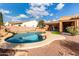 Curved pool with a waterfall feature in the backyard at 23242 S 202Nd Way, Queen Creek, AZ 85142