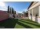 Artificial turf backyard with water feature and patio at 2351 E Cherrywood Pl, Chandler, AZ 85249