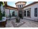 Elegant courtyard with water fountain, stone accents, and lush greenery at 2351 E Cherrywood Pl, Chandler, AZ 85249