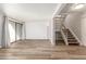 Living room with wood-look floors and access to balcony and stairs at 2524 S El Paradiso -- # 76, Mesa, AZ 85202