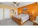 Main bedroom with wood bed frame and access to closets at 26171 W Via Del Sol Dr, Buckeye, AZ 85396