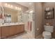 Double vanity bathroom with a large walk-in shower at 26222 W Behrend Dr, Buckeye, AZ 85396