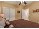 Bedroom with double bed, closet and access to bathroom at 26222 W Behrend Dr, Buckeye, AZ 85396