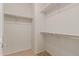 Spacious walk-in closet with double hanging rods and shelving at 26222 W Behrend Dr, Buckeye, AZ 85396