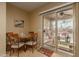 Kitchen dining area with table and chairs, plus backyard access at 26222 W Behrend Dr, Buckeye, AZ 85396