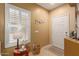 Bright entryway with white door, window shutters, and side table at 26222 W Behrend Dr, Buckeye, AZ 85396