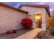 Front entrance with blooming red flowers and walkway at 26222 W Behrend Dr, Buckeye, AZ 85396