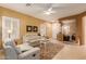 Living room with light leather furniture and view of entryway at 26222 W Behrend Dr, Buckeye, AZ 85396