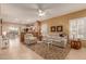 Open living room with beige walls, light leather sofas, and tile floors at 26222 W Behrend Dr, Buckeye, AZ 85396