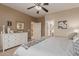 Main bedroom featuring a dresser, king bed, and bathroom at 26222 W Behrend Dr, Buckeye, AZ 85396