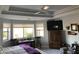 Bright bedroom featuring a large TV and built-in shelving at 2705 S Copperwood --, Mesa, AZ 85209