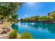 Serene lake view with lush landscaping and walkways at 2746 S Harmony Ave, Gilbert, AZ 85295