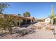 Large backyard with gravel, rock features, and a covered patio at 2747 Leisure World --, Mesa, AZ 85206