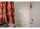 Clean bathroom with a shower/tub combo and red curtain at 2747 Leisure World --, Mesa, AZ 85206