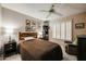 Cozy bedroom featuring a bed, ceiling fan, and window shutters at 2747 Leisure World --, Mesa, AZ 85206