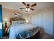 Spacious Primary bedroom with a large bed and ceiling fan at 2747 Leisure World --, Mesa, AZ 85206