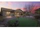 Evening view of backyard, putting green, and home exterior at 28210 N Gedona Way, San Tan Valley, AZ 85143