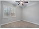 Well-lit bedroom with carpet, ceiling fan, and shutters at 28210 N Gedona Way, San Tan Valley, AZ 85143