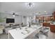 Open concept dining area with seating for six and a modern light fixture at 28210 N Gedona Way, San Tan Valley, AZ 85143