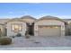 Tan colored house with a two car garage and mature landscaping at 28210 N Gedona Way, San Tan Valley, AZ 85143