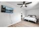 Comfortable bedroom with a queen bed, mounted TV, and ceiling fan at 2826 E Victor Hugo Ave, Phoenix, AZ 85032