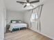 Bright bedroom with a queen bed, ceiling fan and light grey curtains at 2826 E Victor Hugo Ave, Phoenix, AZ 85032