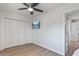 Bedroom with double doors leading to backyard, ceiling fan and hardwood floors at 2826 E Victor Hugo Ave, Phoenix, AZ 85032