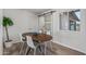 Charming dining area with wood table and white chairs, near sliding barn door at 2826 E Victor Hugo Ave, Phoenix, AZ 85032