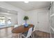 Dining area with wood table and chairs, offering pool views through sliding doors at 2826 E Victor Hugo Ave, Phoenix, AZ 85032