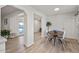 Bright dining area with a wood table and four white chairs, near the kitchen at 2826 E Victor Hugo Ave, Phoenix, AZ 85032