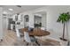 Open dining area with mid-century modern table and chairs, kitchen and living room views at 2826 E Victor Hugo Ave, Phoenix, AZ 85032