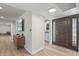 Bright entryway with wood floors, a brown door, and mid century modern console table at 2826 E Victor Hugo Ave, Phoenix, AZ 85032