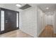 Clean hallway with light wood floors and white painted brick accent wall at 2826 E Victor Hugo Ave, Phoenix, AZ 85032