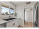 Kitchen features white cabinets, a black sink, and stainless steel appliances at 2826 E Victor Hugo Ave, Phoenix, AZ 85032