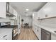 Modern kitchen featuring white cabinets, stainless steel appliances, and quartz countertops at 2826 E Victor Hugo Ave, Phoenix, AZ 85032