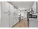 Modern kitchen with white cabinets, quartz countertops and stainless steel appliances at 2826 E Victor Hugo Ave, Phoenix, AZ 85032