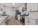 Modern kitchen with white cabinets, stainless steel appliances, and quartz countertops at 2826 E Victor Hugo Ave, Phoenix, AZ 85032