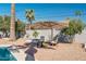 Peaceful poolside patio with comfortable seating and umbrella at 2826 E Victor Hugo Ave, Phoenix, AZ 85032