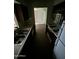 View of kitchen from dining area, features stove and refrigerator at 2835 N 49Th St, Phoenix, AZ 85008