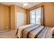 Well-lit bedroom with double door closet and window at 29711 N Yellow Bee Dr, San Tan Valley, AZ 85143