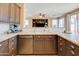 L-shaped kitchen with island, granite countertops and stainless steel appliances at 29711 N Yellow Bee Dr, San Tan Valley, AZ 85143