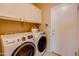 Laundry room with washer, dryer, and upper cabinets at 29711 N Yellow Bee Dr, San Tan Valley, AZ 85143