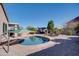 Cool off in this kidney-shaped pool with a pergola and patio umbrella at 29711 N Yellow Bee Dr, San Tan Valley, AZ 85143