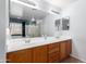 Double vanity bathroom with large mirror and neutral tones at 29808 N Yellow Bee Dr, San Tan Valley, AZ 85143